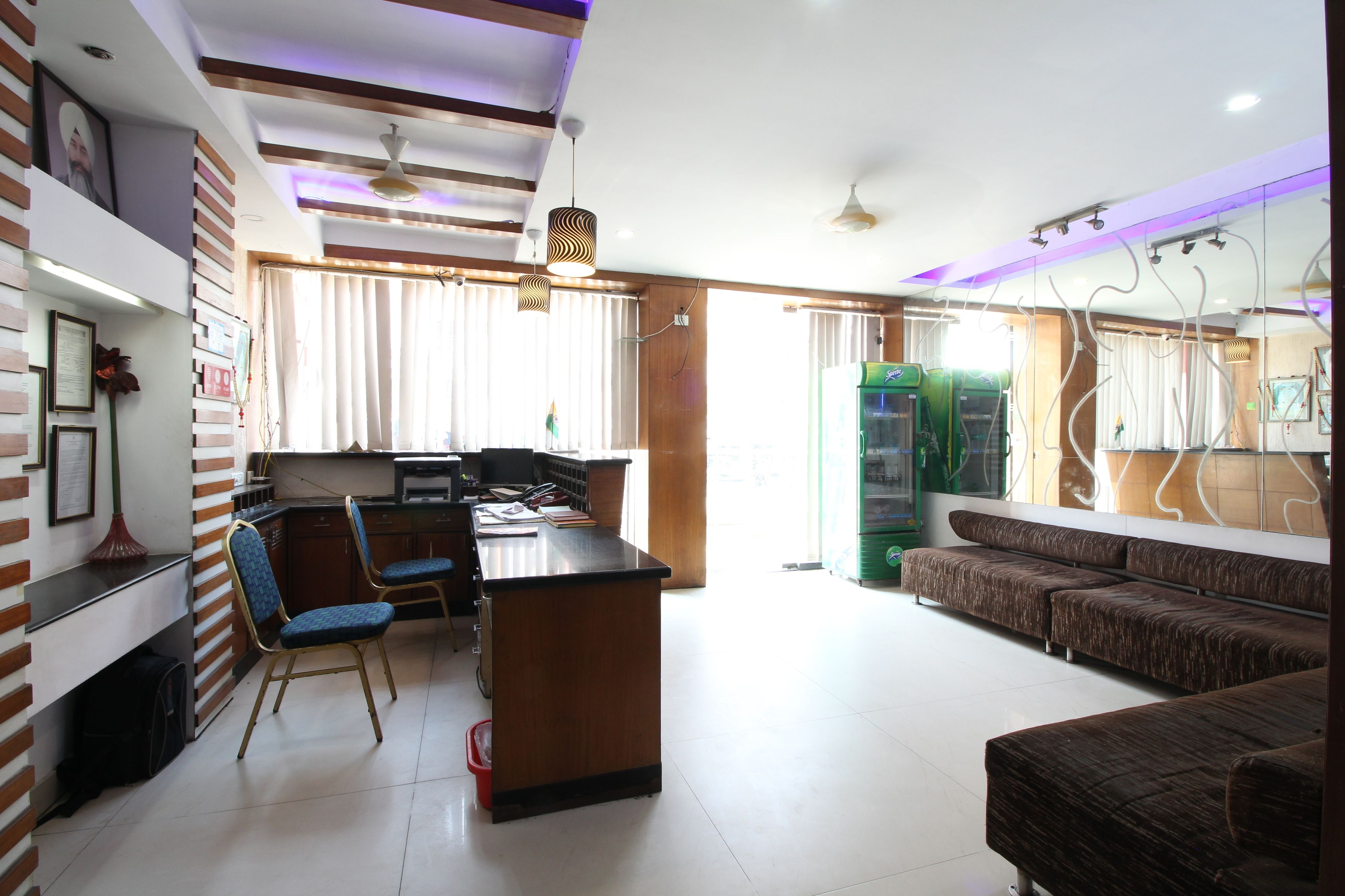 A modern kitchen with a dining area, a sofa, and a TV.