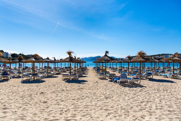 White sand, sun-loungers, beach umbrellas
