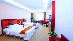 A hotel room with two beds, a desk, a chair, a TV, and a plant. - Days Inn By Wyndham City Centre Xian (Xi'an)