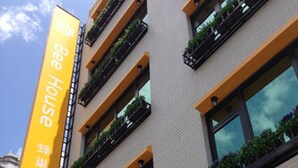 A building with a sign that reads "Bee House" and another sign that says "Bee Relax, Bee You". - Bee House by Cosmos Creation-Taipei Main Station (Taipei)