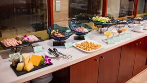 A buffet with various food items, including meats, cheeses, and salads. -  Nesta Hotel Ha Noi (Hanoi)