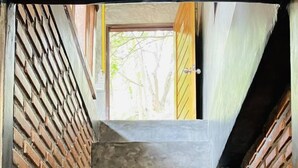 A set of concrete steps leading to a doorway, flanked by brick walls. - Bottle Beach 1 Resort (Ko Pha-ngan)
