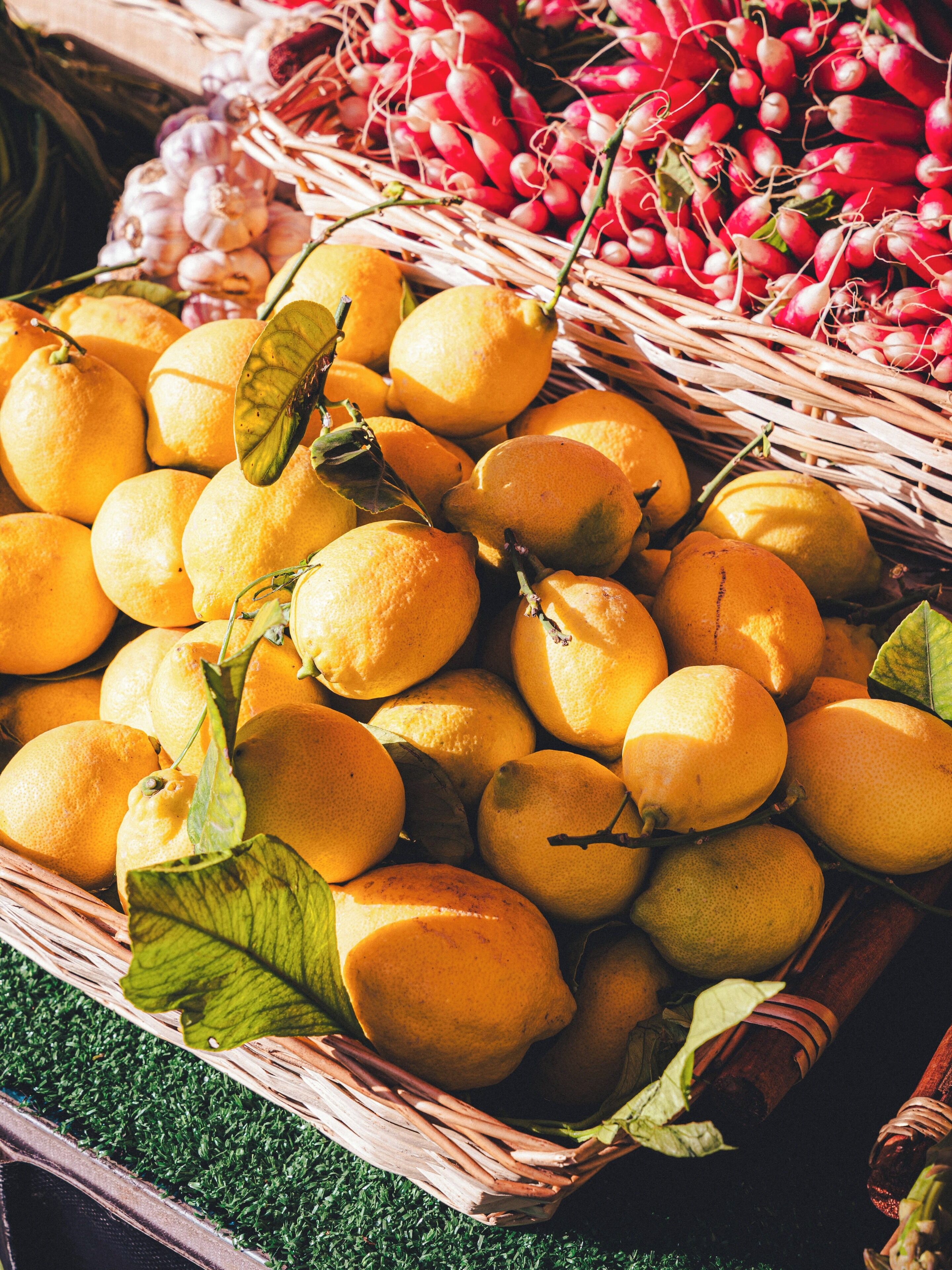 A basket filled with lemons and radishes.