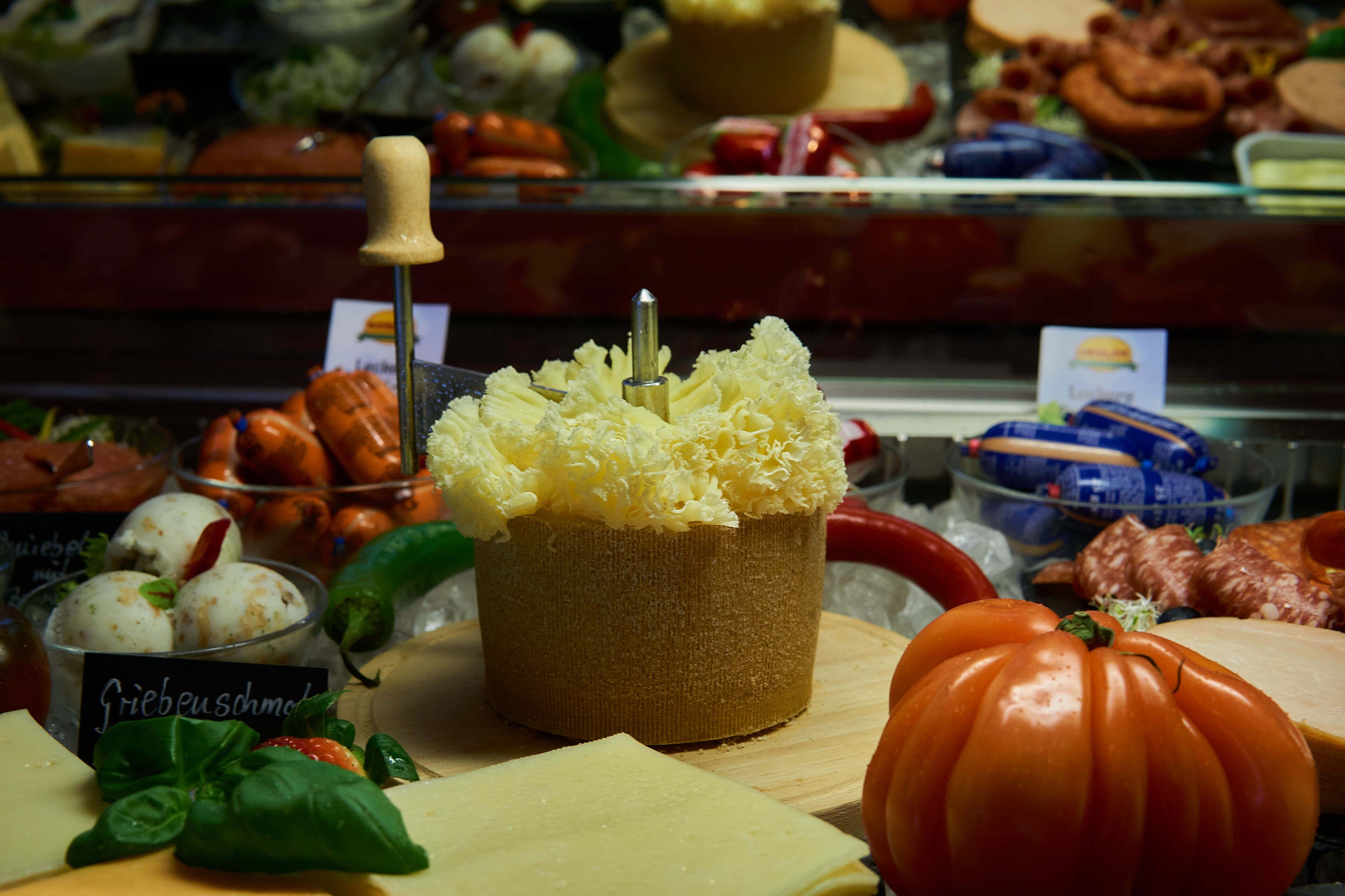 A cheese display with various types of cheese and accompaniments.