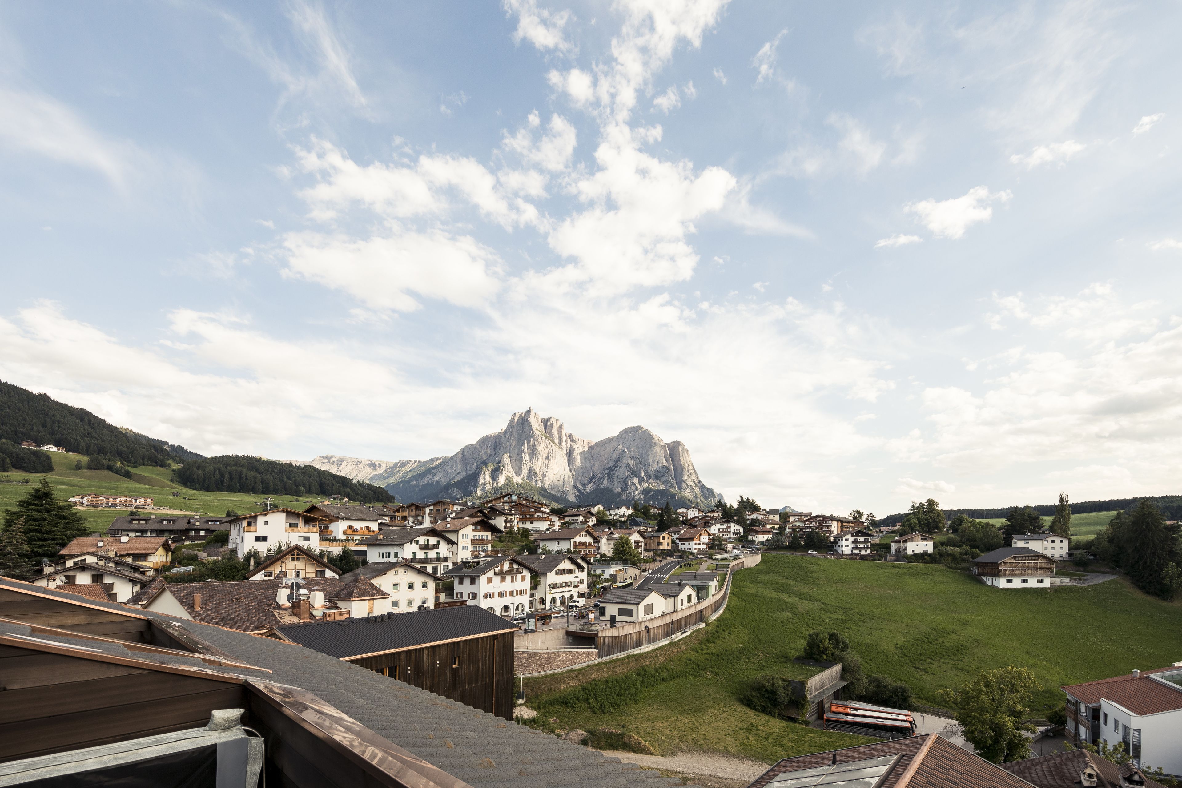 A town with buildings and a mountain in the background.