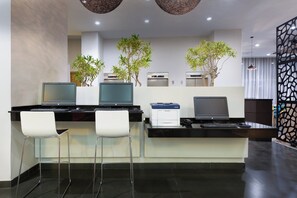 A modern office space with two desks, two chairs, and two printers. - Holiday Inn Panama Distrito Financiero by IHG (Panama City)