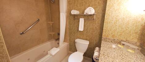 A bathroom with a shower, toilet, and sink.