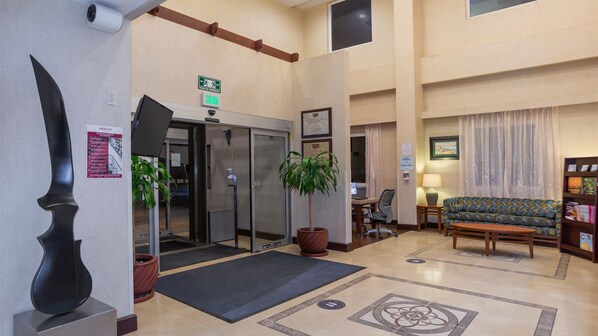 A lobby with a reception desk, a seating area, and a staircase. - Holiday Inn Express Hotel & Suites Cuernavaca by IHG (Cuernavaca)