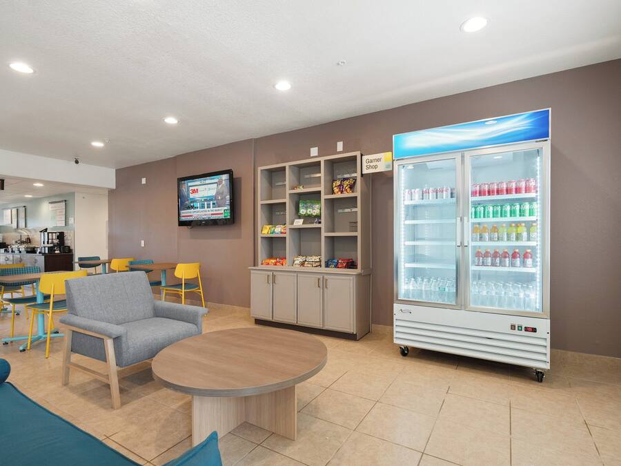 A lobby with seating, a snack bar, a television, and a beverage refrigerator.