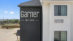 A building with a sign that reads "Garnier BY IHG." - Garner Hotel Gonzales by IHG (Gonzales)