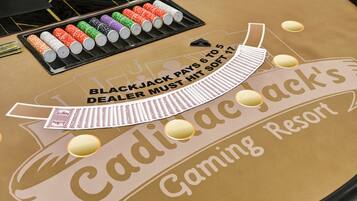 A blackjack table with chips and cards at Cadillac Casino Gaming Resort.