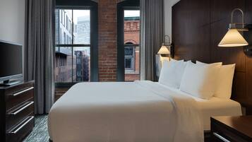 Hypo-allergenic bedding, desk, laptop workspace, blackout drapes