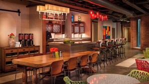 A modern restaurant with wooden tables and chairs, a bar area, and a mix of traditional and contemporary decor. - Residence Inn by Marriott Boston Downtown/Seaport (Boston)