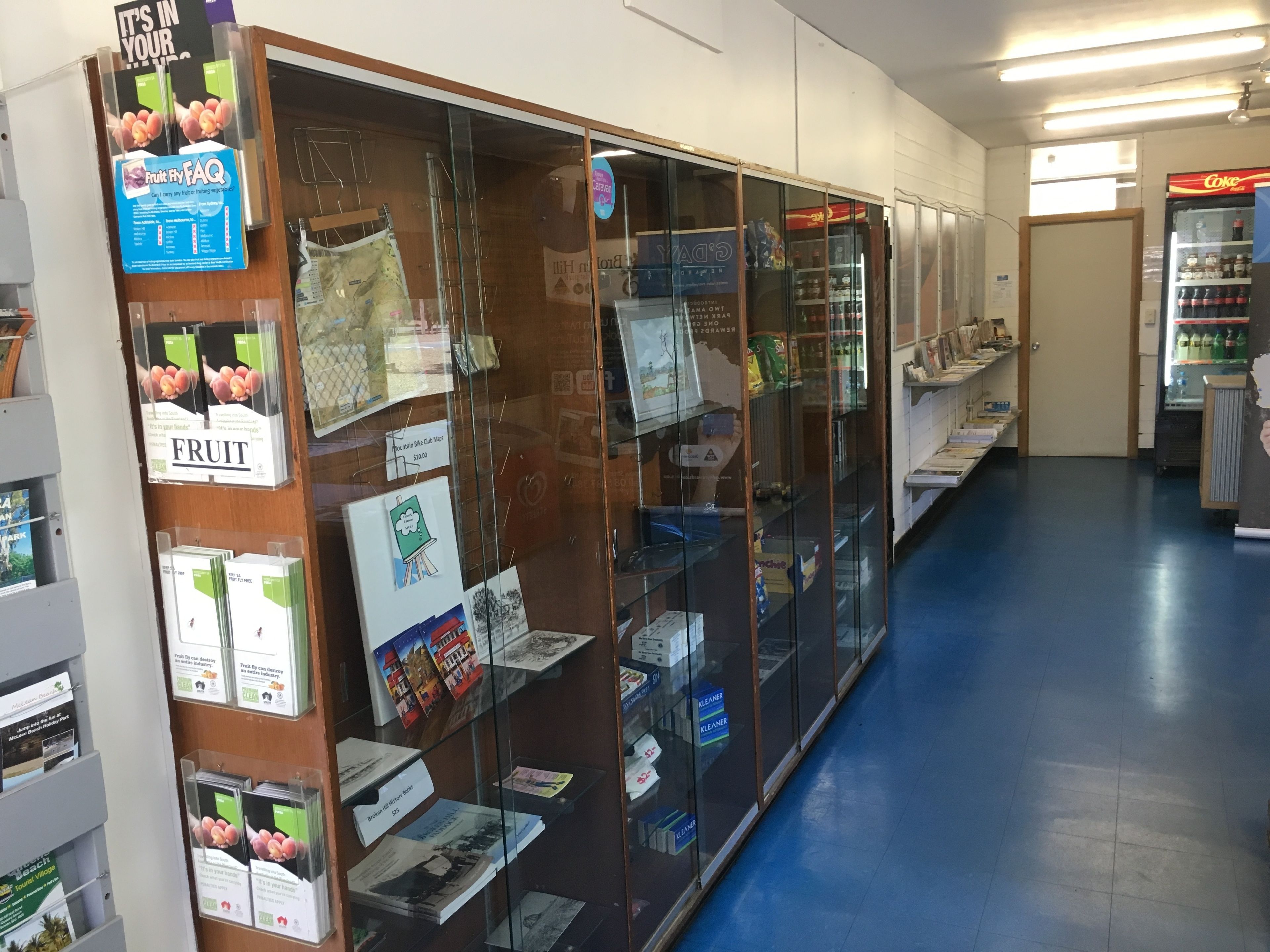 A bookstore with glass display cases filled with books and magazines.