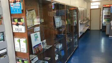 A bookstore with glass display cases filled with books and magazines.
