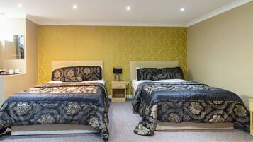 A double bed room with a yellow wall and a carpeted floor.