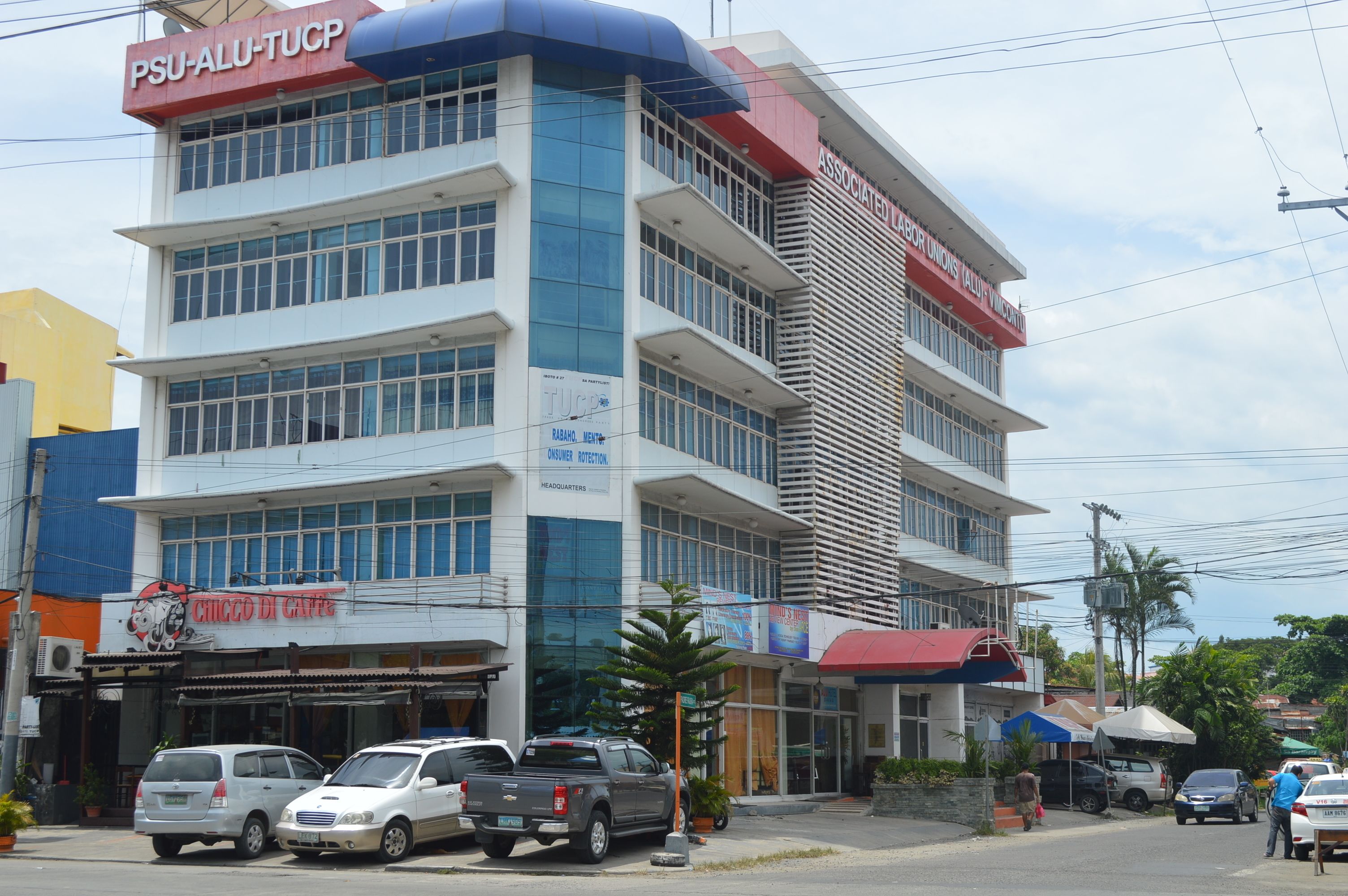 A multi-story building with signage for 'PSU-ALU-TUCP' and 'Associated Labor Union'.