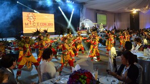 A conference with a stage, attendees seated at round tables, and a performance area. - ALU Hotel Davao (Davao)