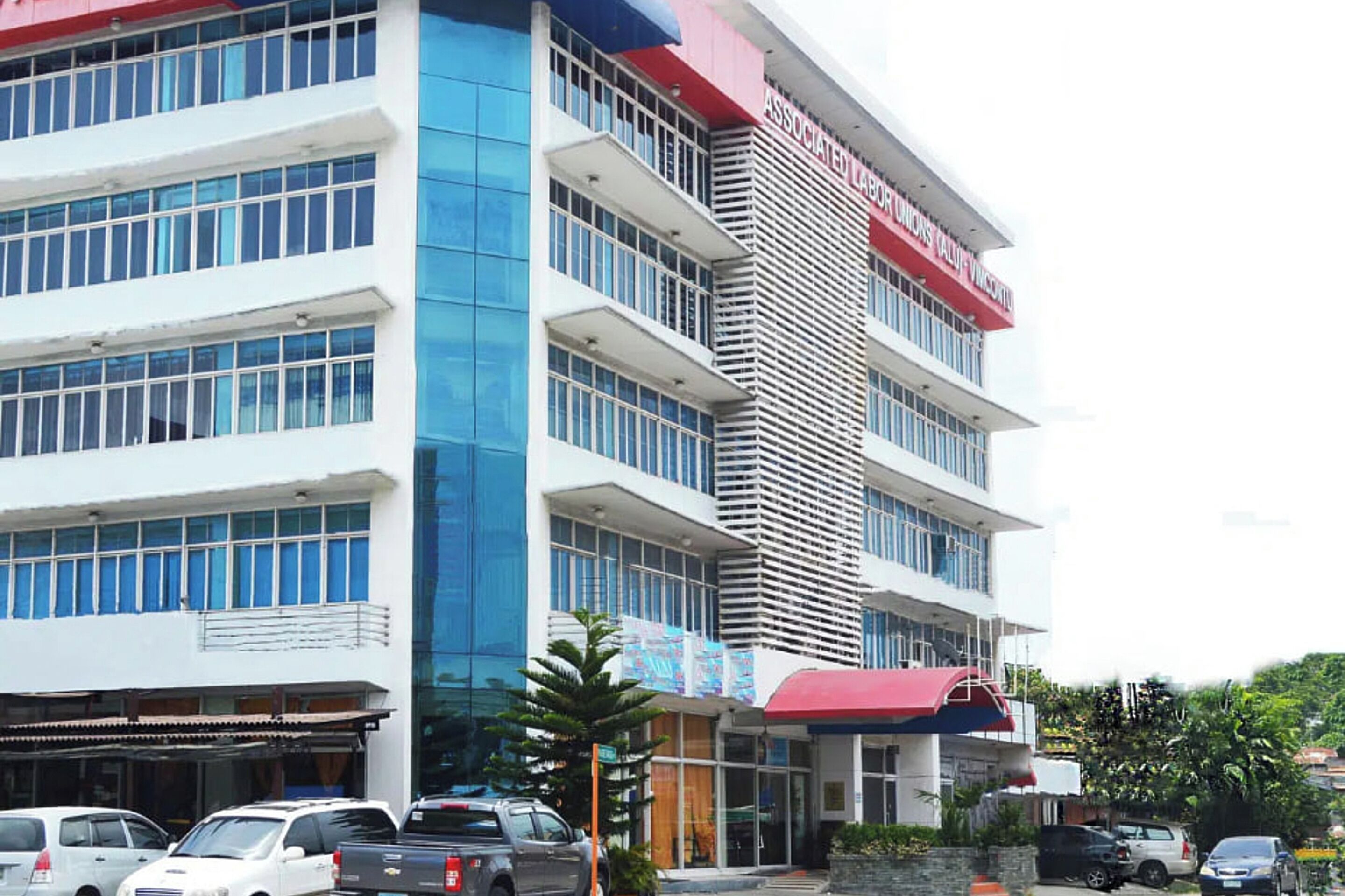A multi-story building with a prominent red and white sign reading "ASSOCIATED LABOR UNIONS".