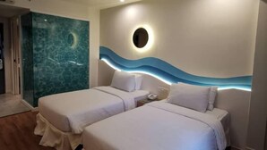 A hotel room with two beds, a round mirror, and a wall with a wave design. - Oceania Hotel (Kota Kinabalu)
