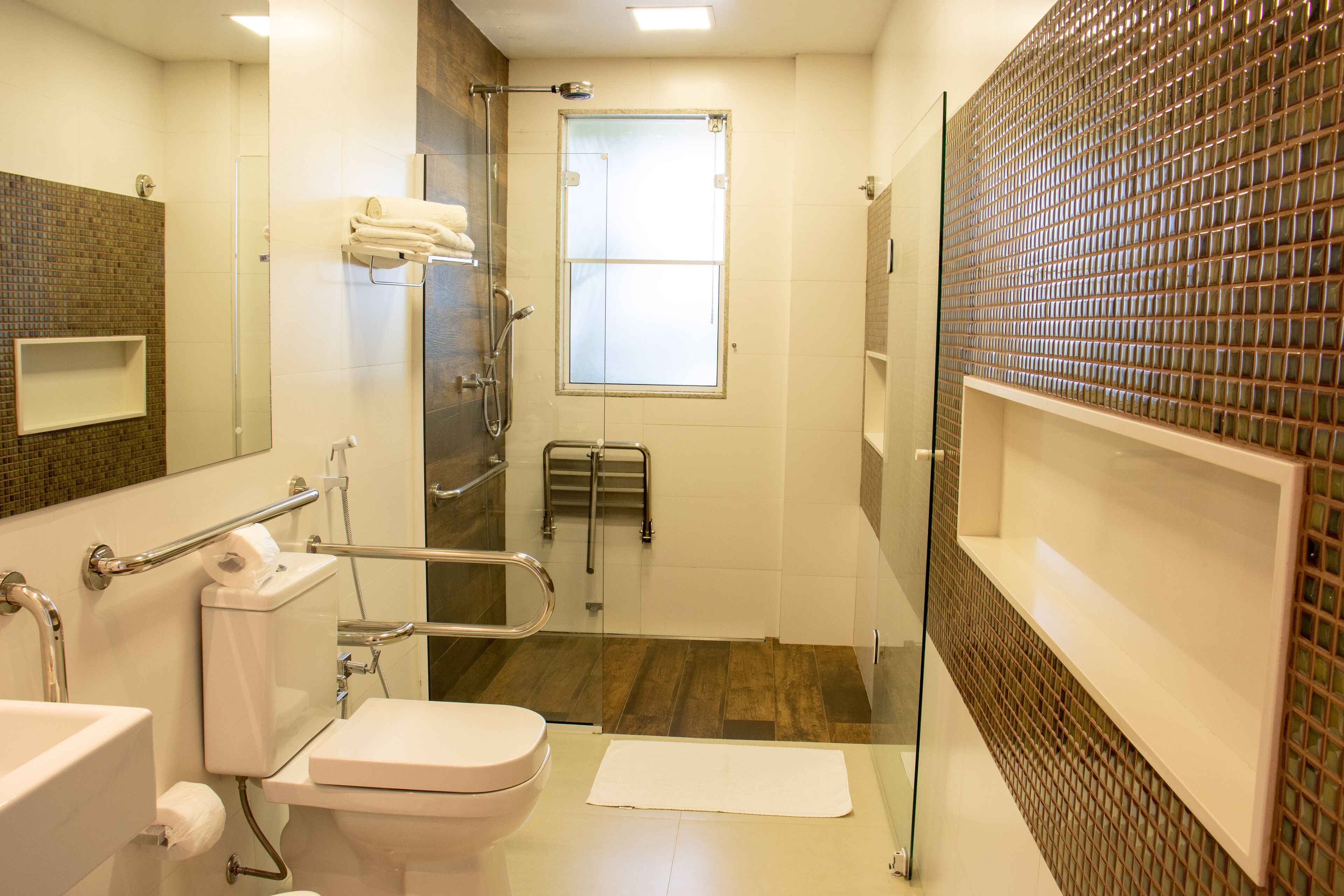 A modern bathroom with a toilet, bidet, and shower.