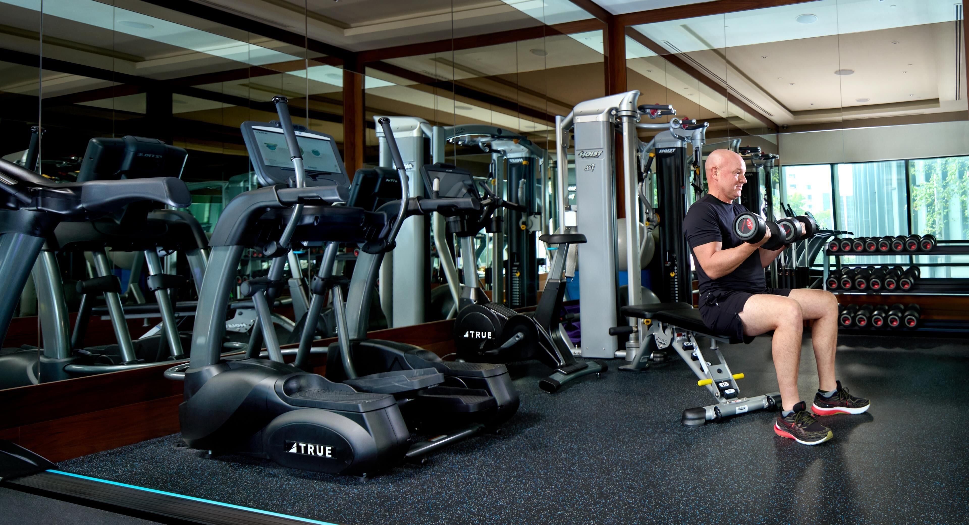 A gym with exercise equipment, including treadmills and weight machines.