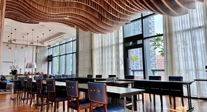 A modern dining area with high ceilings, large windows, and contemporary furniture. - Carlton City Hotel Singapore (Singapore)