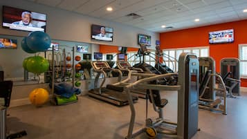 A gym with treadmills, exercise balls, and weight machines.