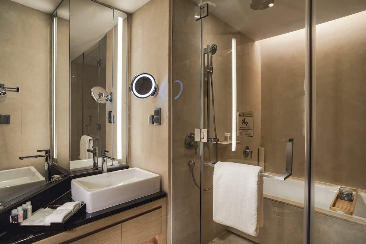 deep-soaking bathtub, rainfall showerhead, designer toiletries