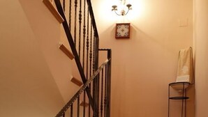 A staircase with patterned tiles and blue underglow lighting. - Hotel L'Antic Portal (Vilafames)