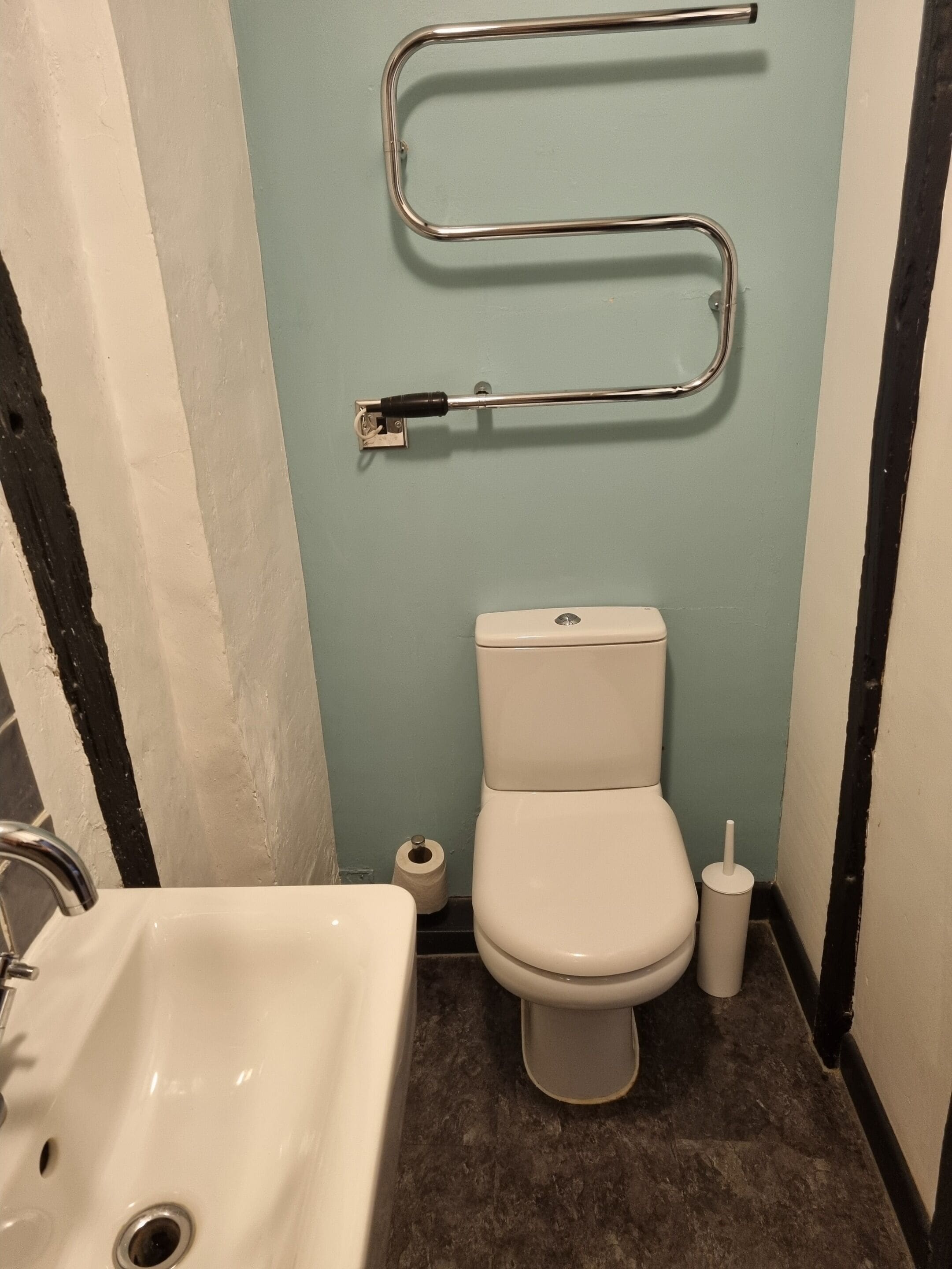 A bathroom with a toilet, bidet, and sink.