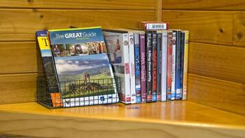 A bookshelf with a variety of books and DVDs, including titles like 'The GREAT Guide' and 'SKILLING THEM SOFTLY'.