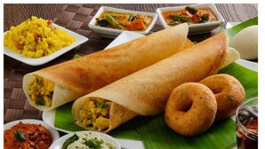 A meal with two wraps, two small round breads, and three small bowls of different dishes. -  Parijatha Gateway (Bengaluru)