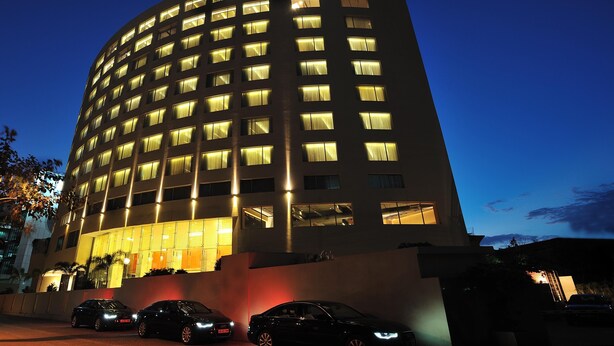 A multi-story hotel with the name 'ANYA' illuminated on the top. - The Anya Hotel, Gurgaon (Gurugram)