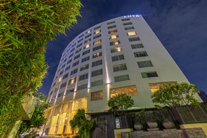 A multi-story hotel with a modern design, featuring a prominent 'ANYA' sign at the top.