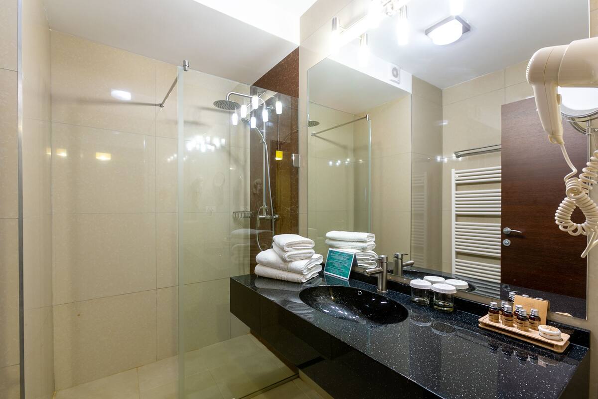 prestige suite | bathroom | rainfall showerhead, free toiletries, hair dryer, bathrobes