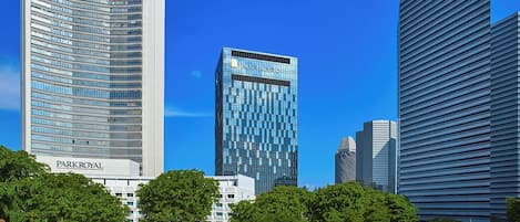 A modern cityscape with high-rise buildings, including a prominent white building with 'PARKROYAL' signage.