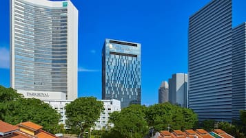 A modern high-rise hotel with a curved facade, a prominent 'Parkroyal' sign, and a 'Bank of the West' sign.