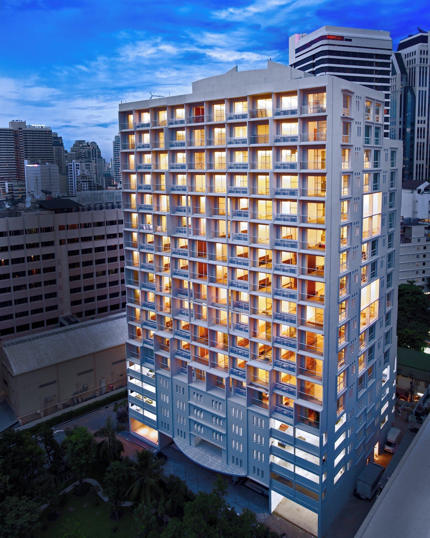A high-rise hotel with a grid of balconies and multiple floors.