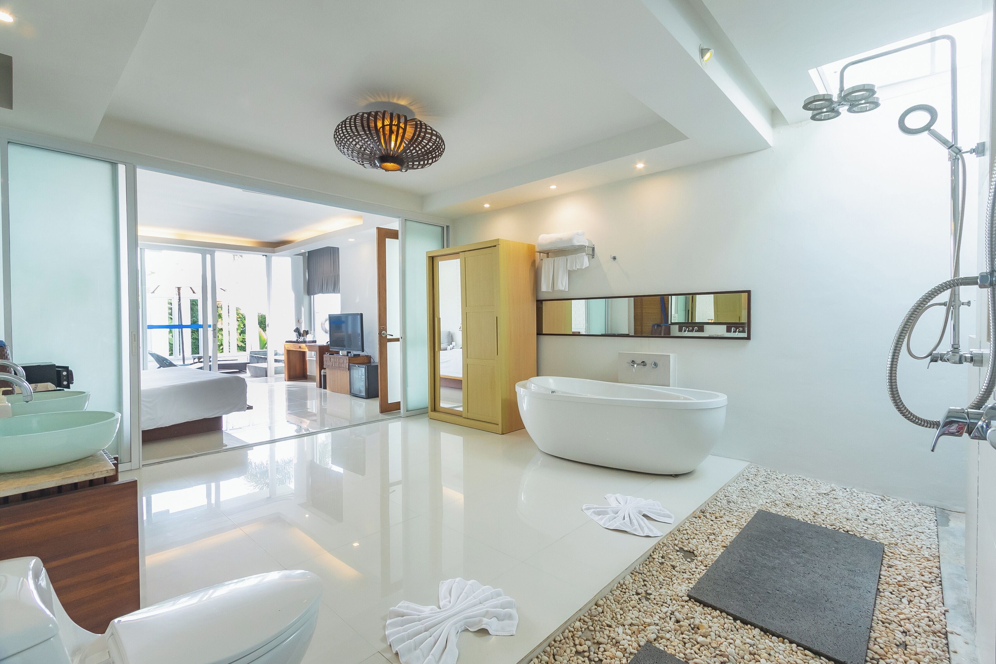 two-bedroom pool villa | bathroom | separate bathtub and shower, rainfall showerhead, designer toiletries