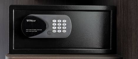 A black electronic keypad lock on a wooden surface.