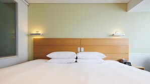 A neatly made bed with white linens and pillows, a wooden headboard, and bedside lamps. - NINE TREE BY PARNAS SEOUL MYEONDONG 1 (Seoul)