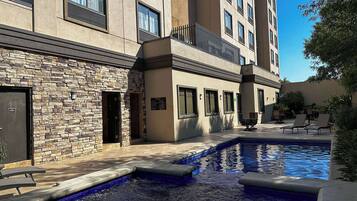 Outdoor pool, open 7:00 AM to 10:00 PM, pool loungers