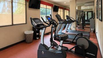 A gym with treadmills, an elliptical, and a stationary bike.