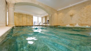 A large indoor swimming pool with clear water, surrounded by ornate walls and columns. - L'Alexain Hôtel Restaurant & Wellness (Niedermorschwihr)