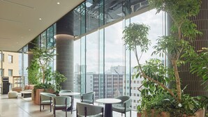 A spacious indoor area with large windows, modern furniture, and indoor plants. - Mitsui Garden Hotel Sendai (Sendai)