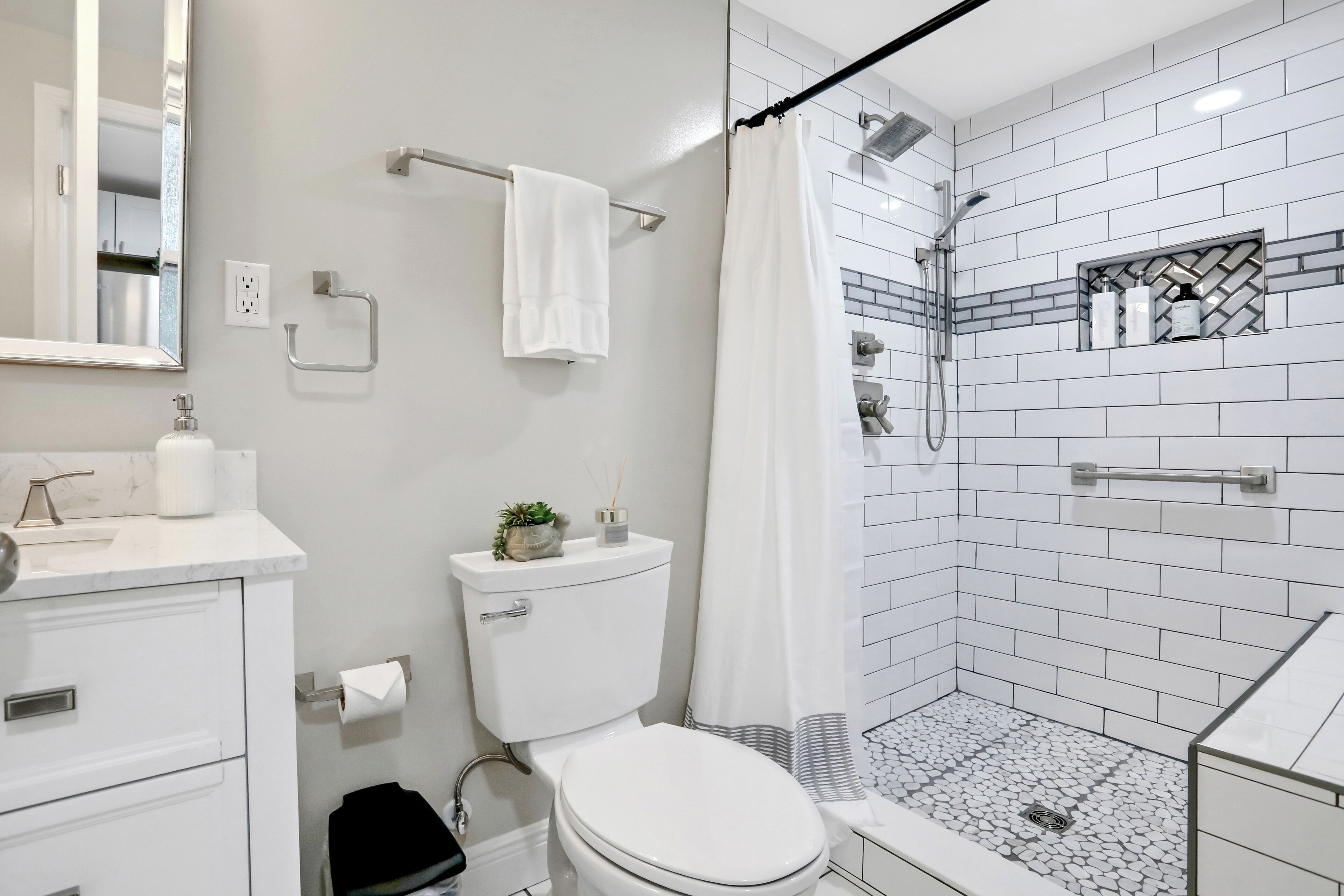 Un baño moderno con inodoro, lavamanos y ducha.