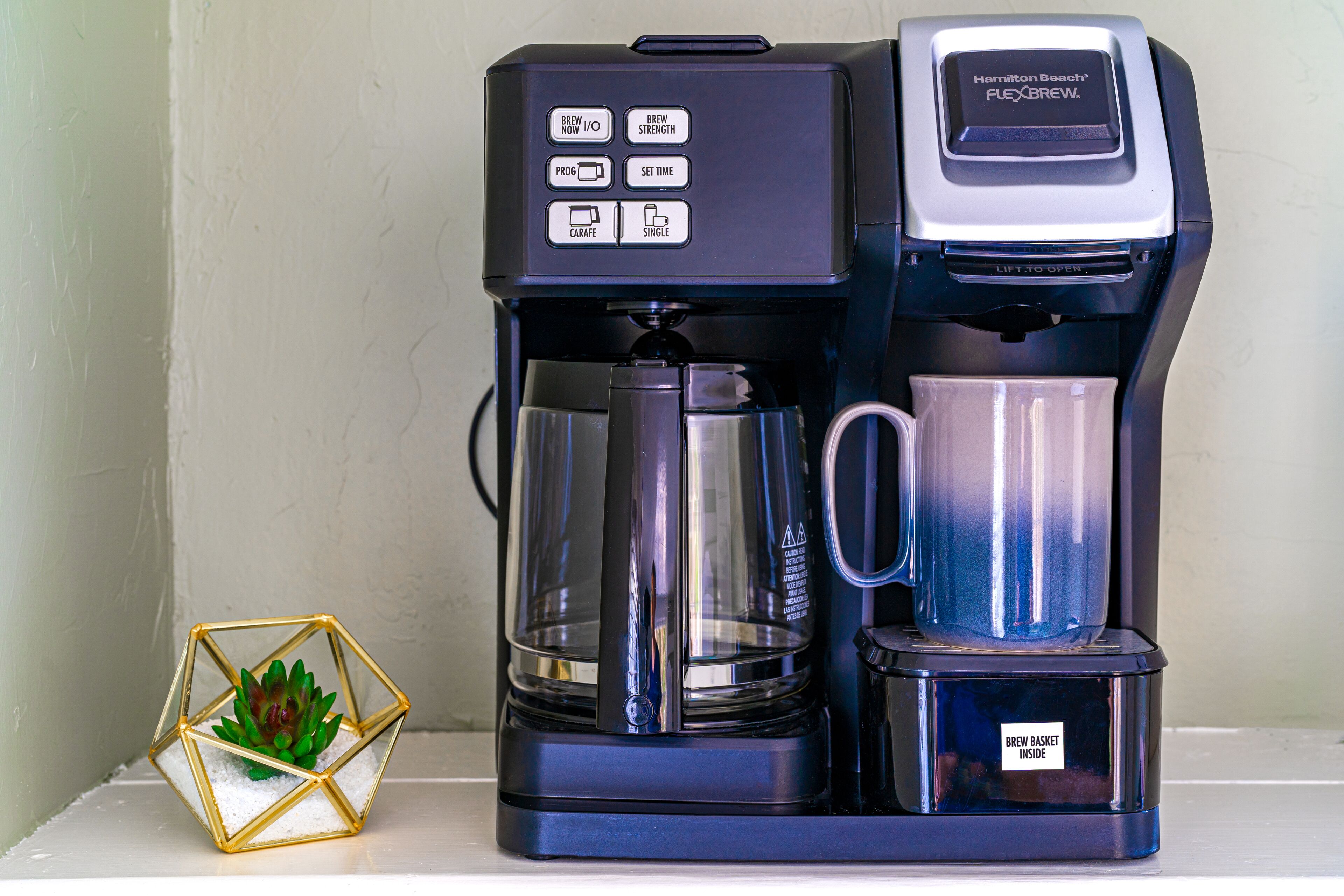 A Hamilton Beach Flexbrew coffee maker with a drip tray and a coffee pot.