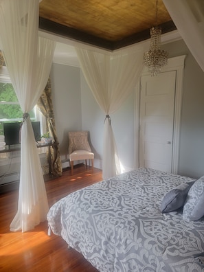 Classic design meets comfort in this well-appointed bedroom with a large bed and stylish chair.