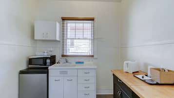 Cocina compacta con microondas, tostadora y lavamanos.
